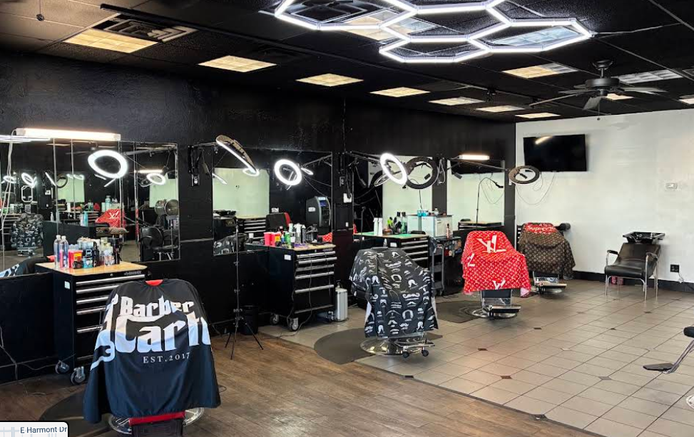 Interior of the shop: barber stations with lighted mirrors, hexagon ceiling lights, and styling chairs